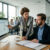 Managers reviewing an occupational health program for compliance risks
